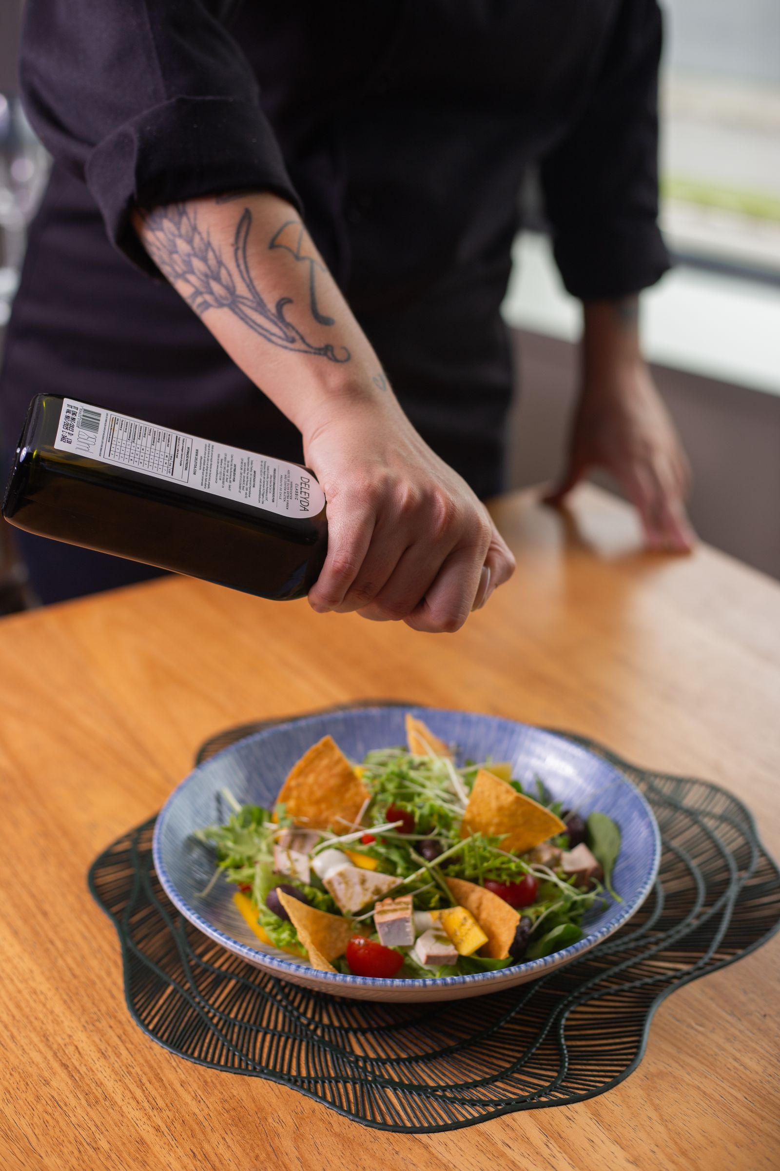 A finished salad mix being dressed