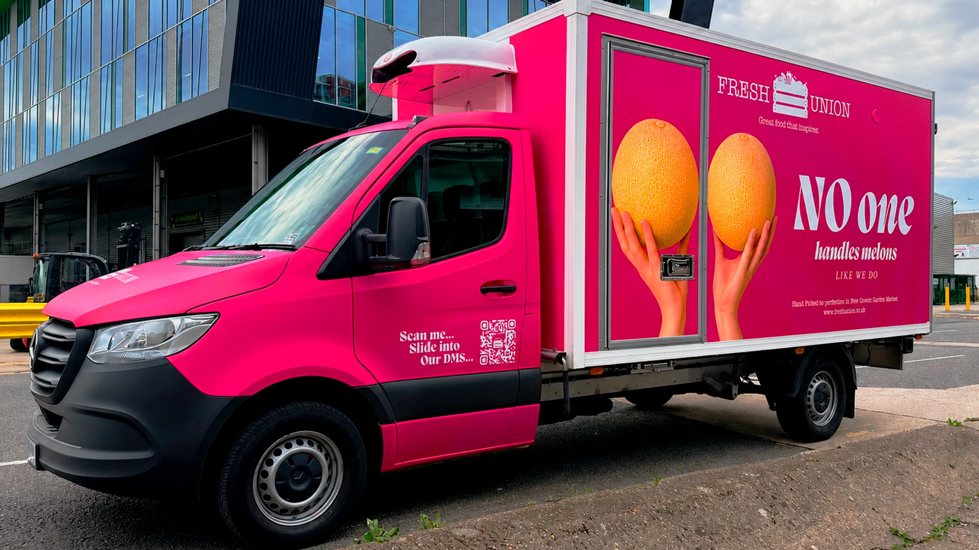 Bright pink Fresh Union refrigerated truck featuring two melons and the slogan ‘No one handles melons like we do’